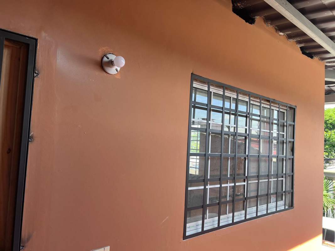 Apartment exterior showing terracotta wall window bars and metal roofing Paraiso Panama rental