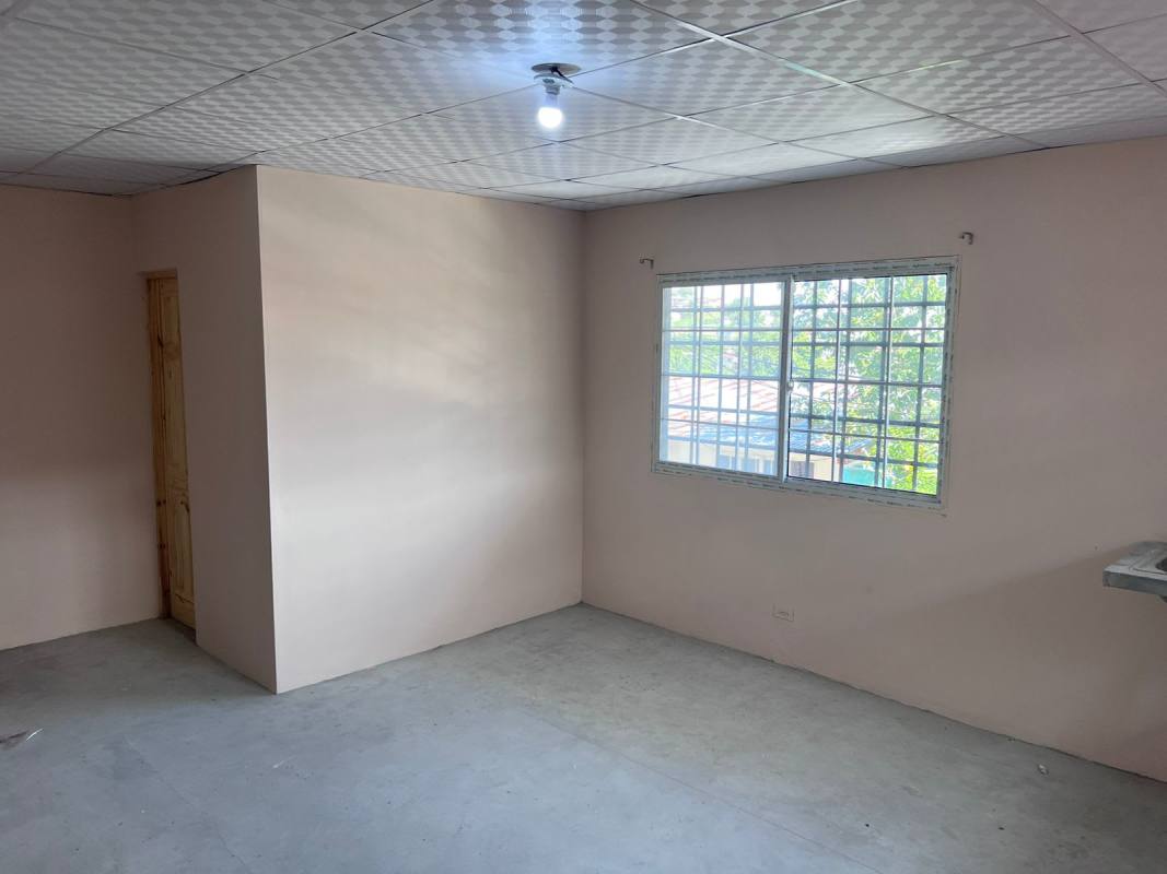 Unfurnished living area with large window and unfinished floor in Paraiso Panama apartment