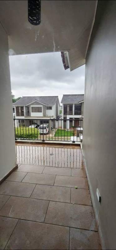 Covered balcony with tiled floor and view of neighboring residential houses at PH Olympus & PH MontBlanc Brisas del Golf Panama