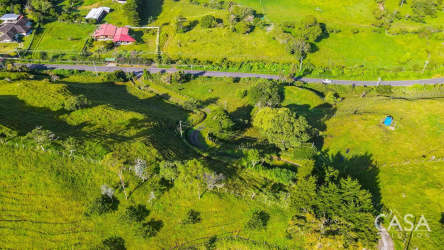 Aerial showing country road, green fenced fields, rural landscape in Volcán Chiriquí land for sale
