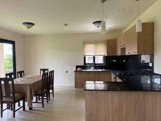 Two-story Mediterranean style house with balcony and stone wall at Los Molinos Boquete