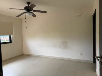 Minimalist empty bedroom with tile floor white walls and ceiling fan Los Molinos Boquete Panama