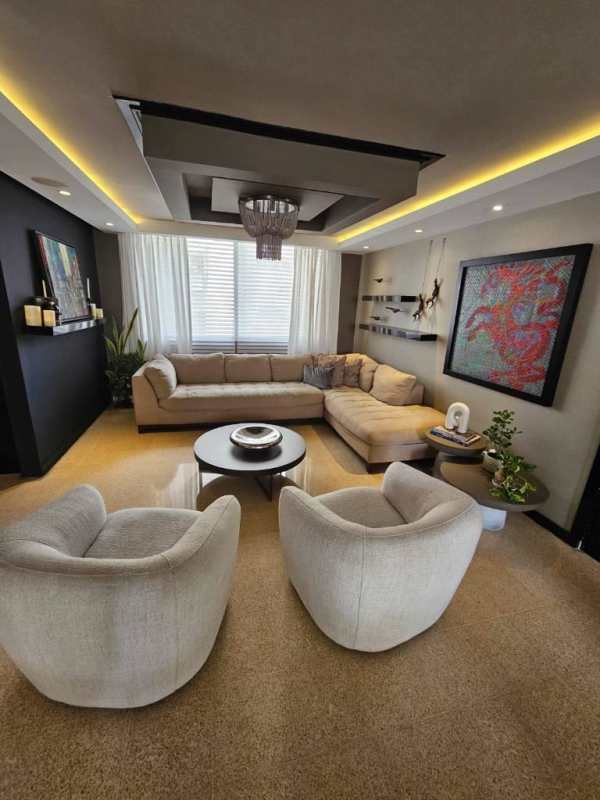 Contemporary dining space with chandelier, large mirror and open layout at PH La Concha Marbella