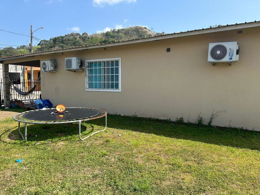 Backyard view with fencing and ACs in Praderas del Norte Tocumen Panama