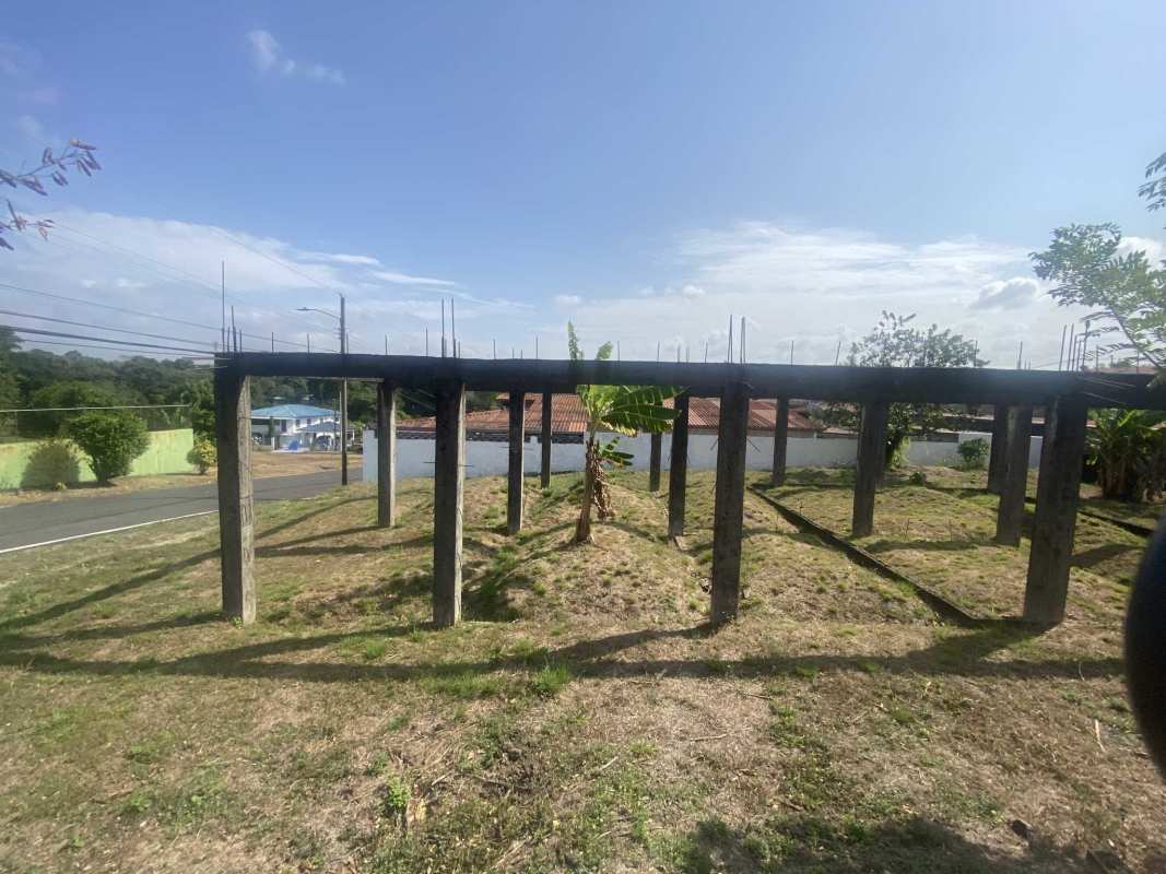 Unbuilt concrete framework on grassy lot in suburban Las Cumbres Villa Alpina Panama