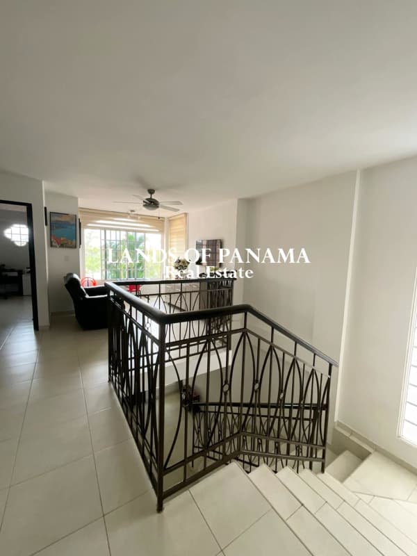 Spacious kitchen featuring island bar and granite counters in Villa Valencia Costa Sur Panama