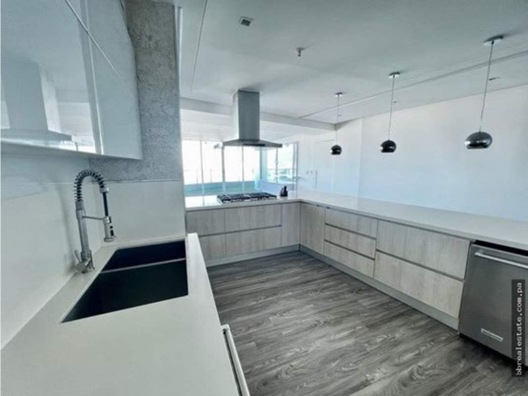 Modern L-shaped kitchen with pendant lights, quartz countertops, stainless appliances in PH Joy Tower Panama City