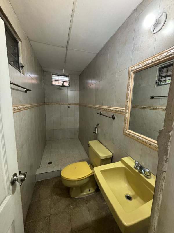 Large bright living and dining room with tiled floors and ceiling fan