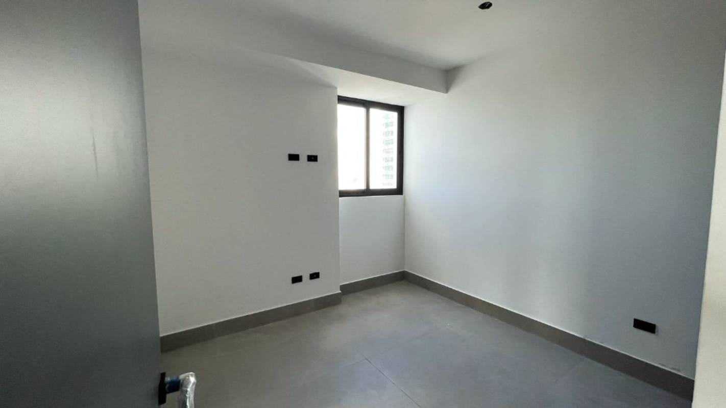 Modern bright bedroom with large window city view PH Victory Sport Coco del Mar Panama