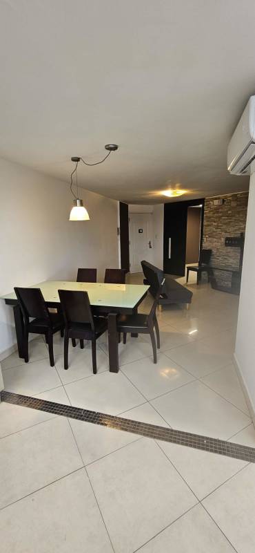 Dining area with glass table, pendant lighting, neutral tiles inside Jardines de Costa del Este furnished apartment for rent