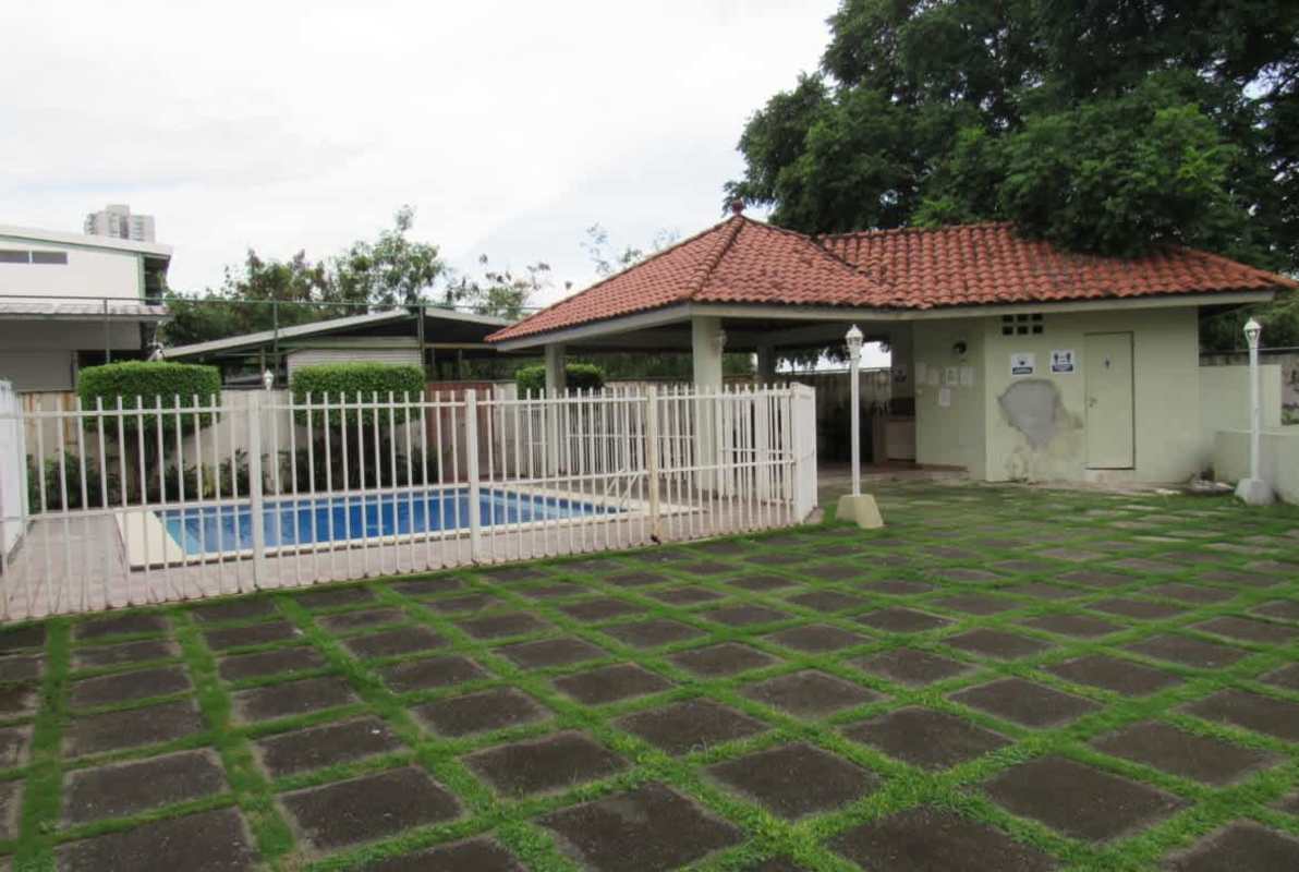Community swimming pool with landscaped gardens inside Jardines de Costa del Este Panama City