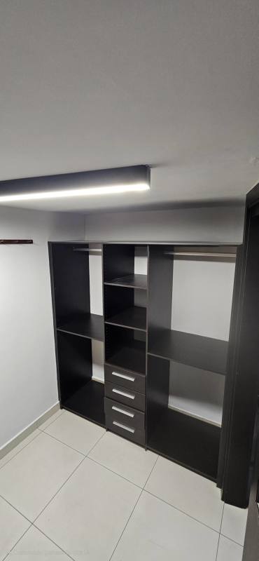 Fenced outdoor swimming pool and patio at Jardines de Costa del Este in Costa del Este Panama