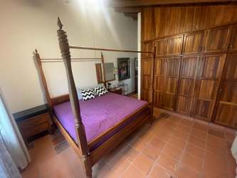 Traditional kitchen with green cabinets, sink and window in Coronado Panama rental house