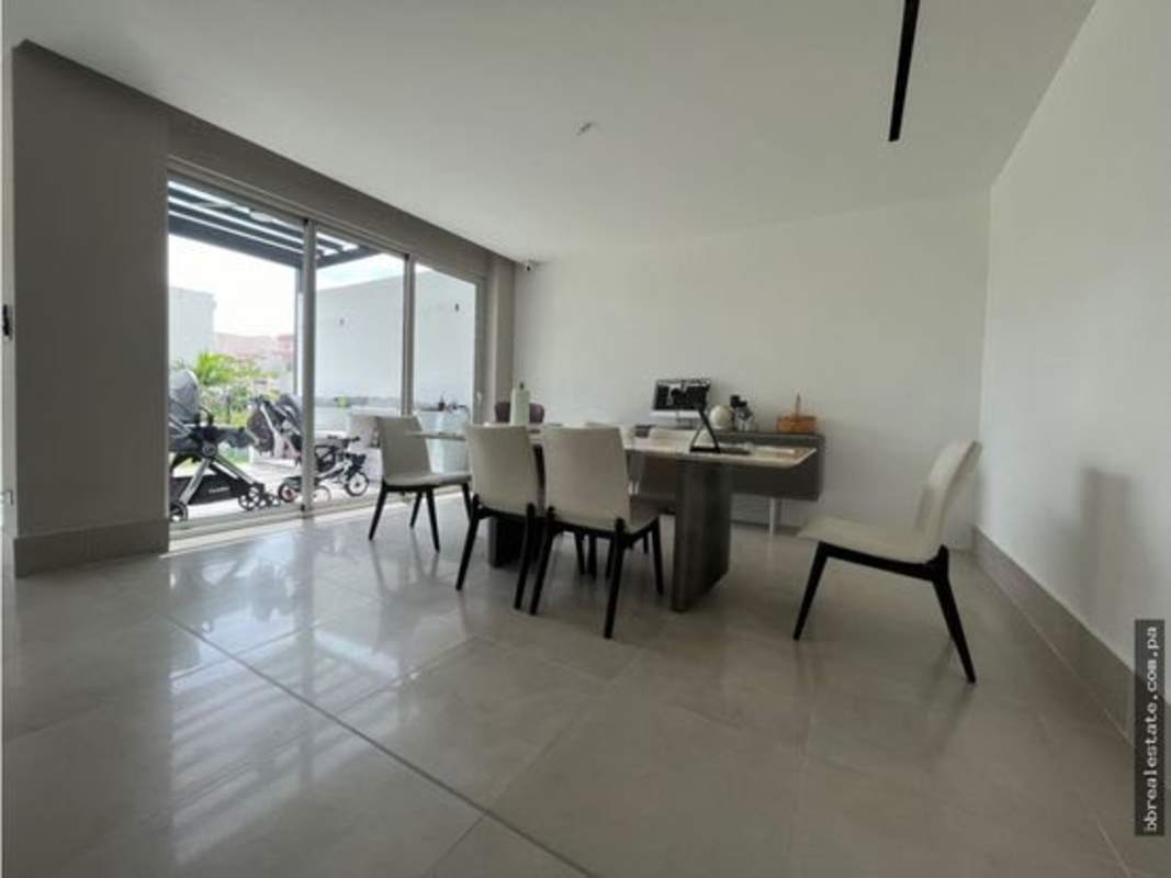 Bright dining space with sliding doors and garden view in Santa Maria Golf Panama