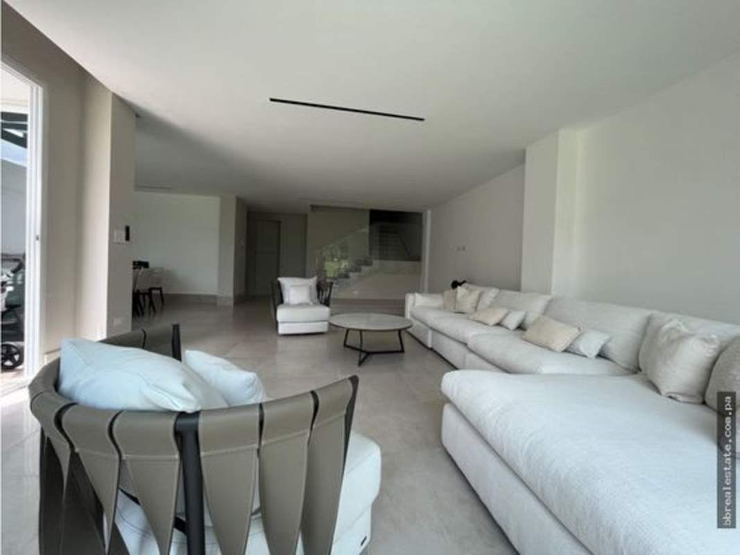 Spacious bathroom with marble tiles, glass shower enclosure, and luxury fixtures in Santa Maria Panama