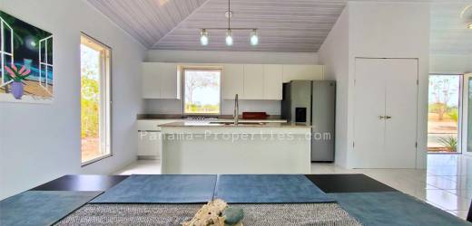 Swimming pool and green painted single family home in Punta Mala Pedasi Panama