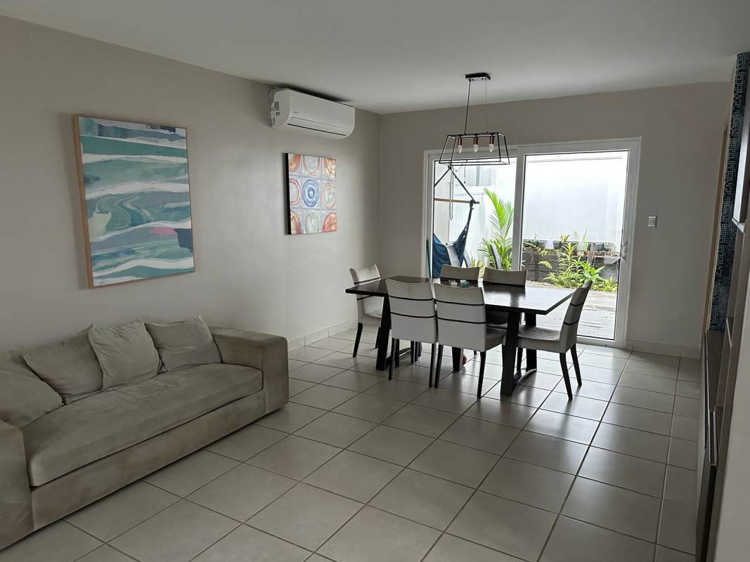 Staircase area with tall vertical windows providing bright light in Brisas del Golf rental house Panama
