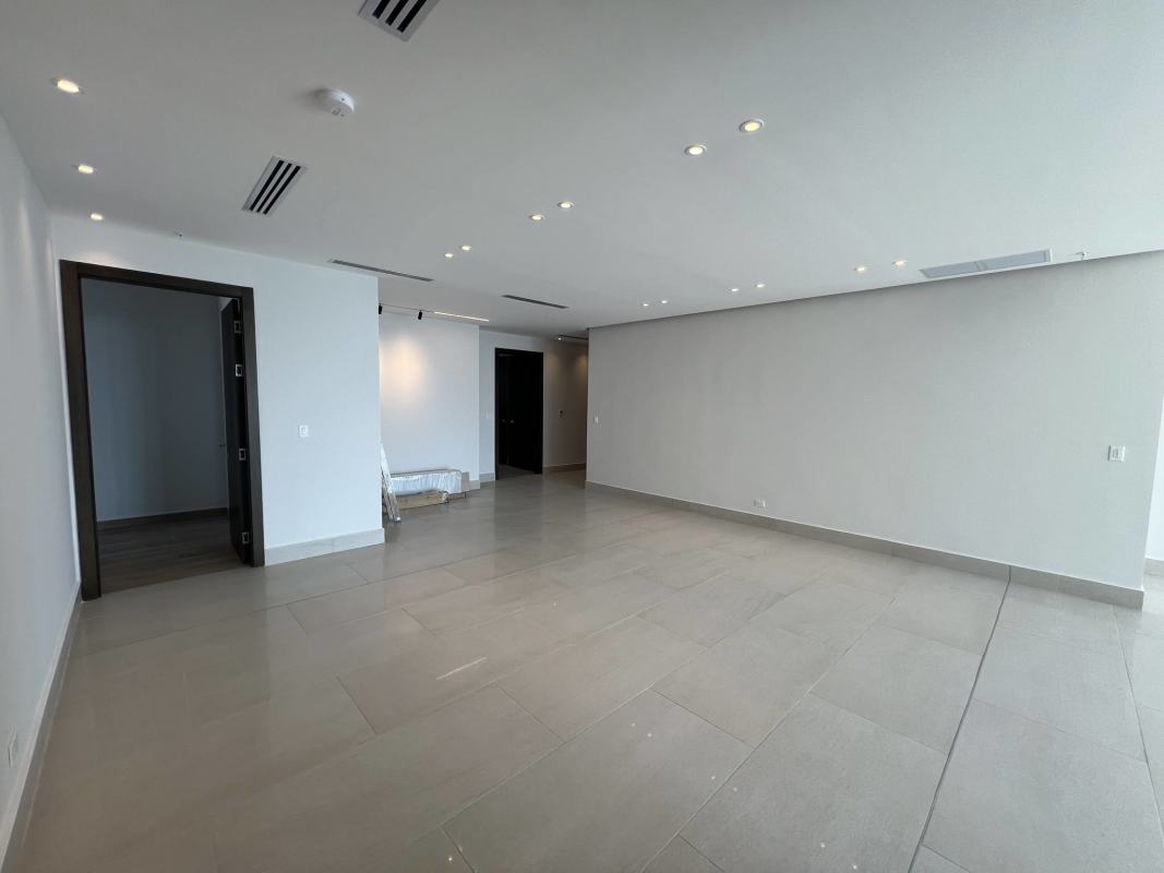 Spacious bedroom with floor-to-ceiling window overlooking Panama City skyline PH Sea Point Punta Paitilla