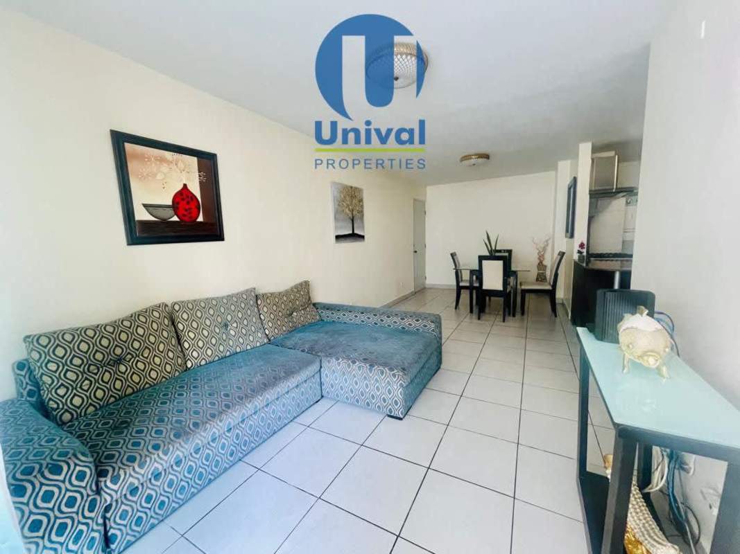 Modern kitchen with granite countertops stacked washer dryer stainless steel appliances PH Altos del Condado