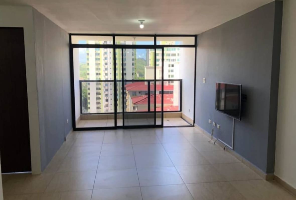 Bright living room with sliding glass doors leading to balcony overlooking city PH Terraza del Rey Condado del Rey Panama