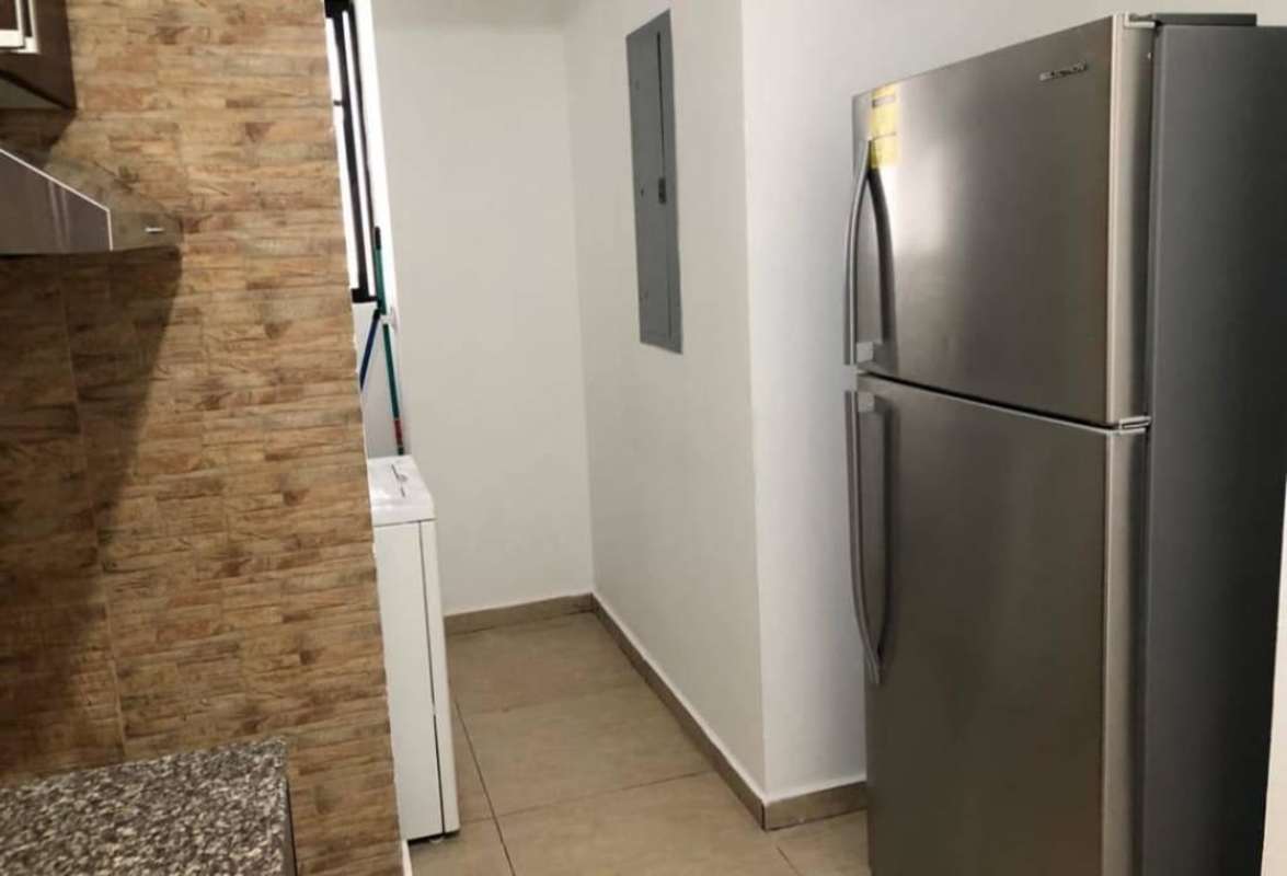 Modern kitchen with granite countertops, refrigerator, washer, tile backsplash in PH Terraza del Rey Condado del Rey Panama