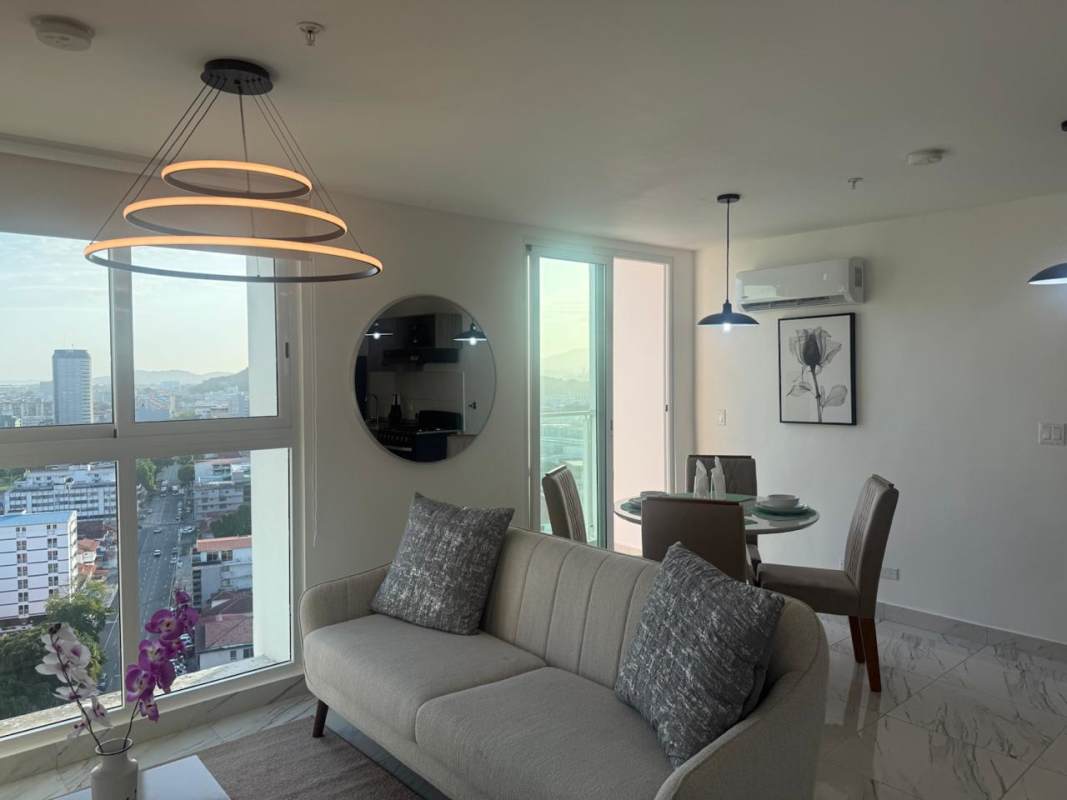 Bright bedroom with large window overlooking Panama City in PH El Botánico Bella Vista