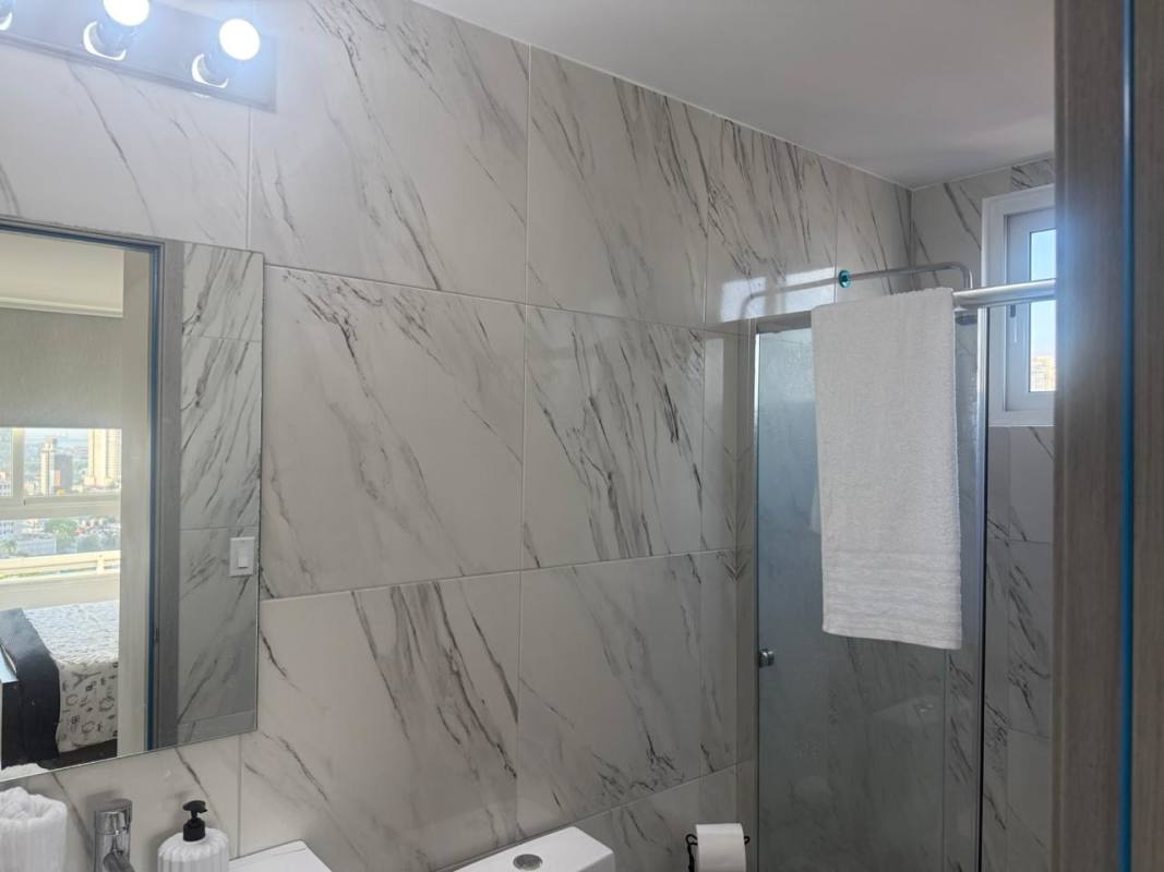 Bedroom with large window, skyline view and modern decor PH El Botánico Panama