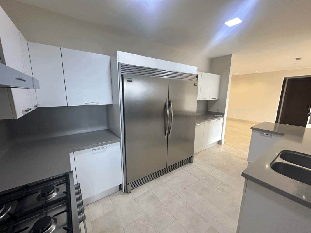 Spacious bedroom with large windows and skyline view in Santa Maria Panama