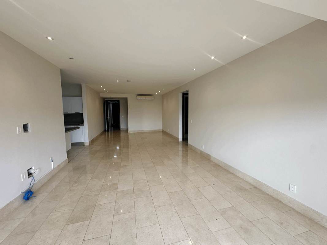 Bright living room with marble floors and balcony overlooking Santa Maria golf