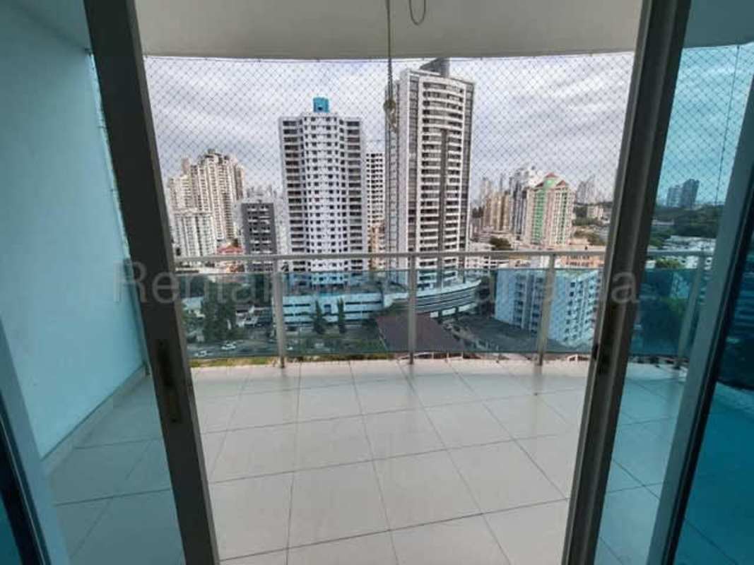 Apartment kitchen with wooden cabinets, granite countertop and large window at PH Mont Royale Panama