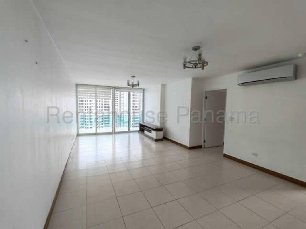 Bright living room with large sliding doors to balcony overlooking Panama City in PH Mont Royale El Cangrejo