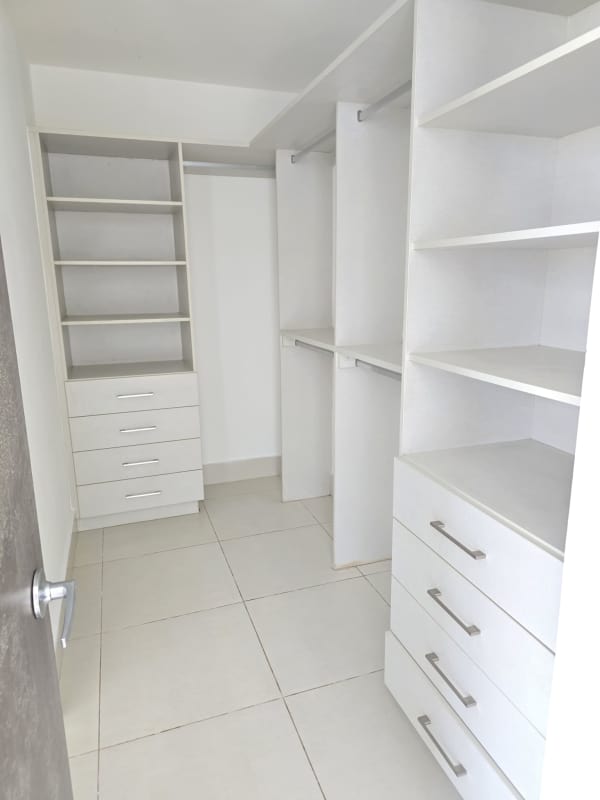Bathroom with black vanity top, glass shower and white tile PH Castellammare Panama