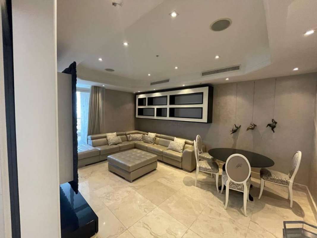 Elegant building lobby with blue wallpaper, floral decor and elevators in PH D1 Punta Paitilla Panama City