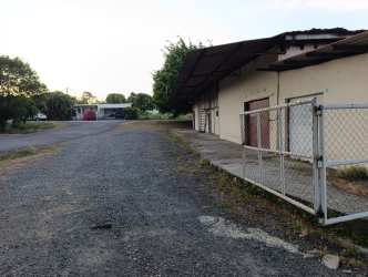 Front view of warehouse with chain-link fence and metal roofing in Canto del Llano Santiago de Veraguas Panama