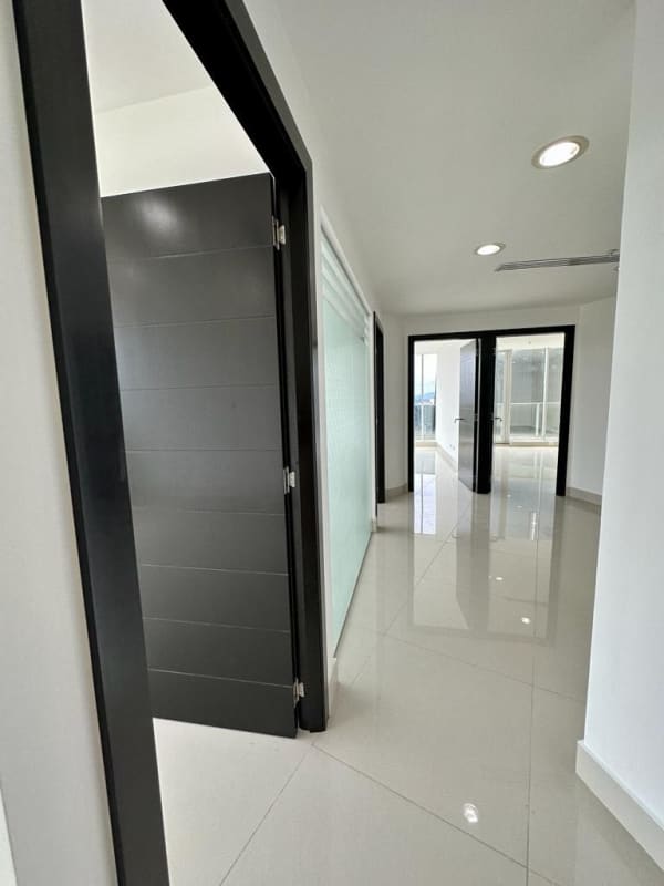 Spacious hallway with frosted glass partition and black trim in luxury office suite F&F Tower Obarrio Panama