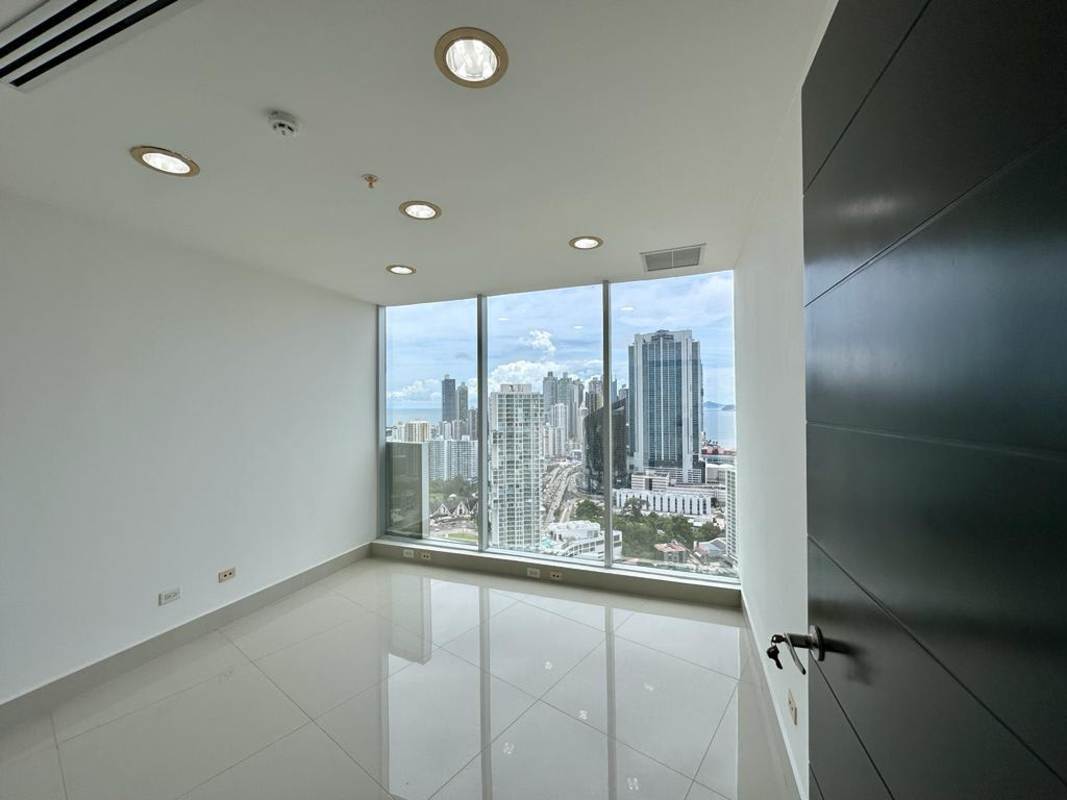 Empty glass-walled meeting or boardroom with panoramic city view in F&F Tower luxury office Panama