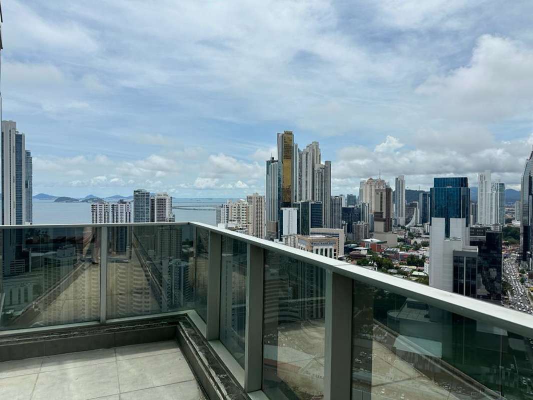 Glass railing balcony on high-rise luxury office tower F&F Tower with panoramic city and ocean view
