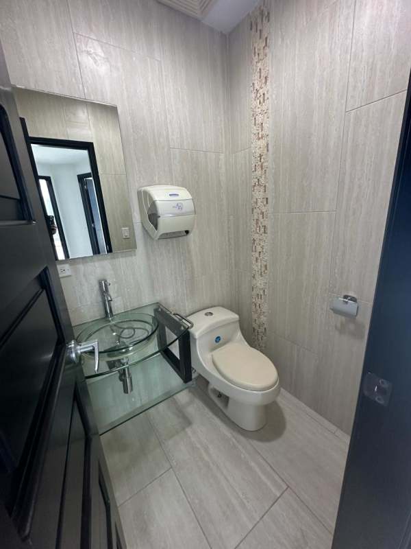 Modern bathroom with glass sink and mosaic tile in F&F Tower office Panama