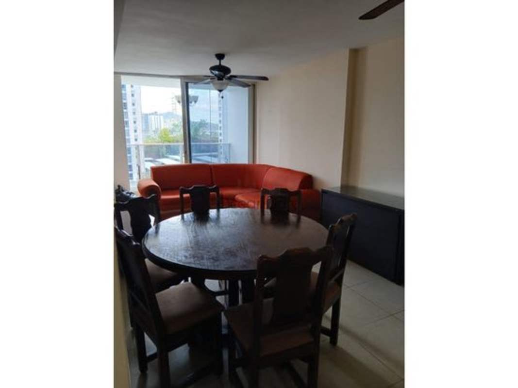 Living dining open room with orange sectional sofa and access to balcony at PH Rokas Condado del Rey Panama