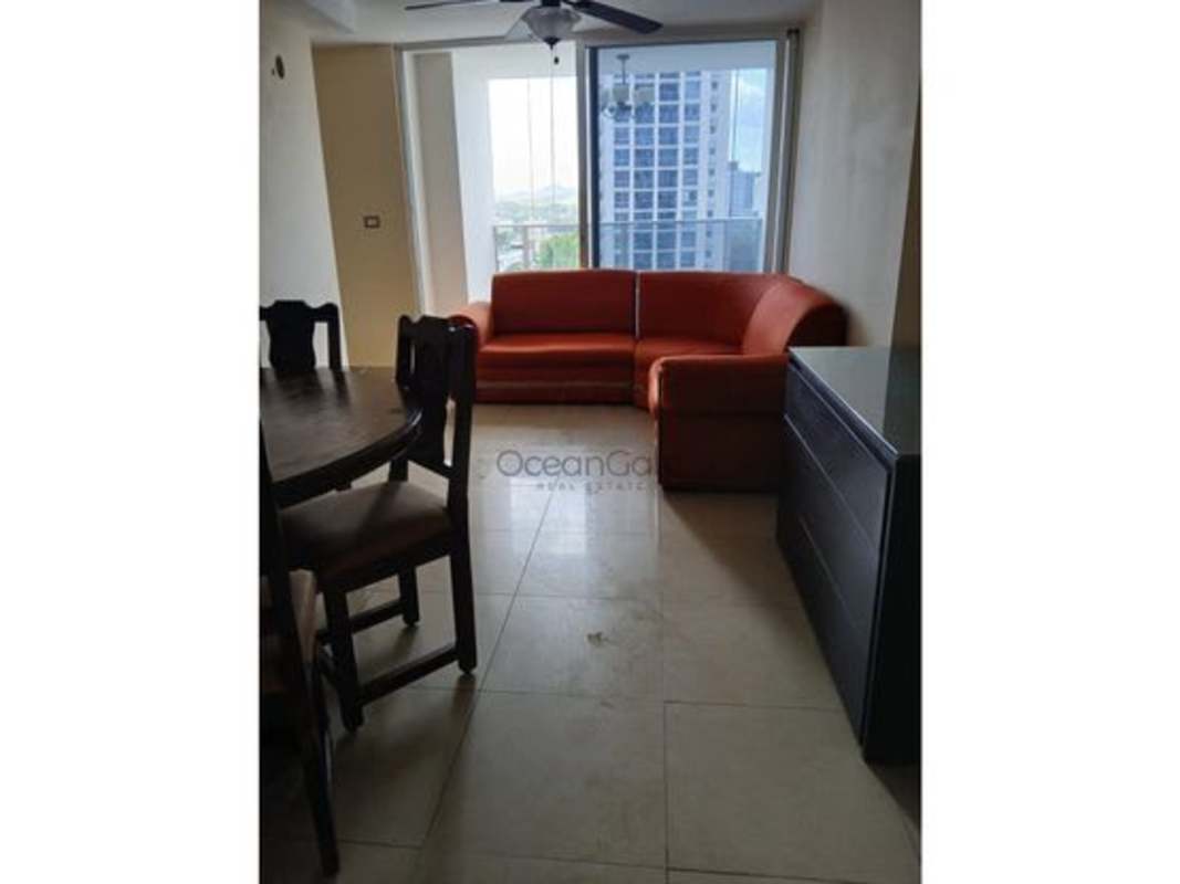 Dining room with round wooden table, ceiling fan in PH Rokas Condo Panama City