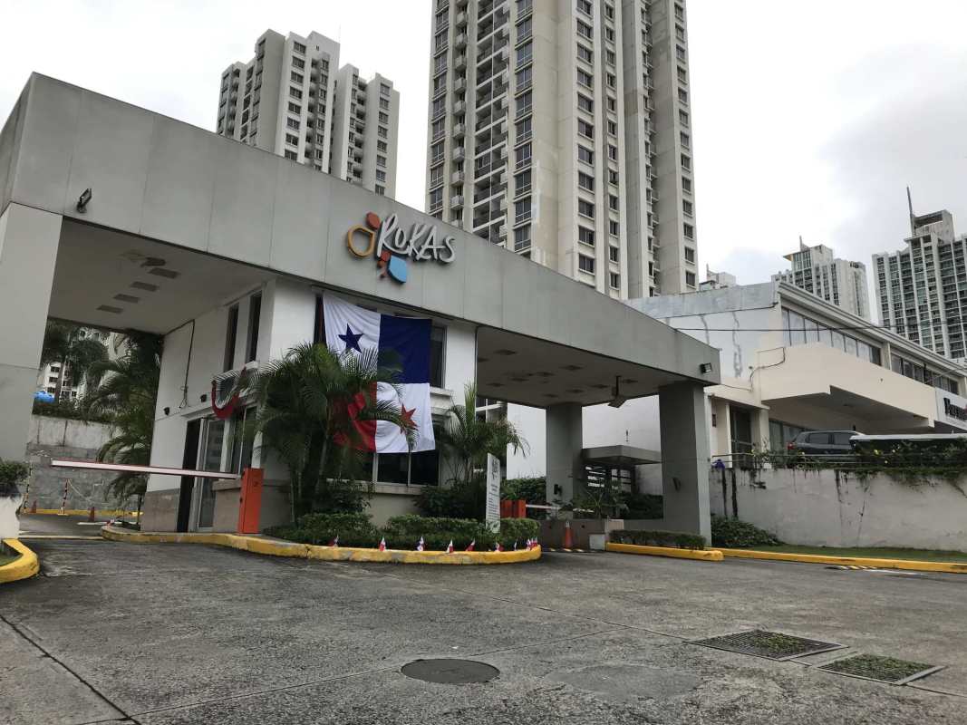 Secured gated entrance with Panama flag at PH Rokas residential complex Panama City
