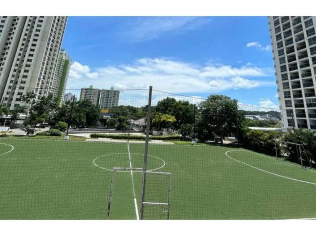 Outdoor football field surrounded by high-rise towers at PH Rokas Condado del Rey