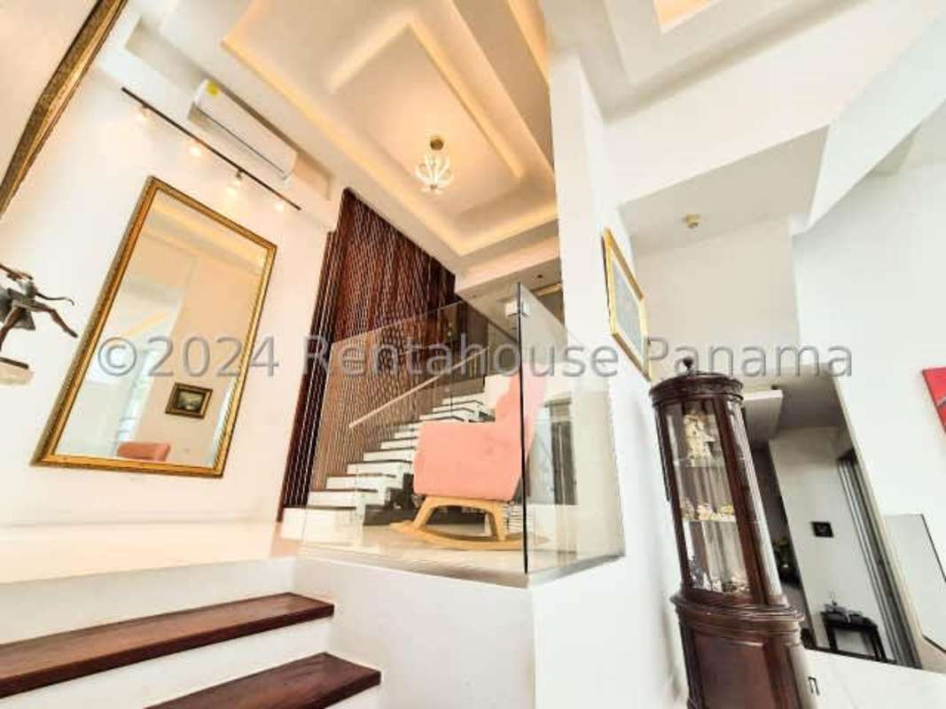 Modern granite kitchen with island and bar seating in luxury home in Altos del Golf Costa del Este Panama