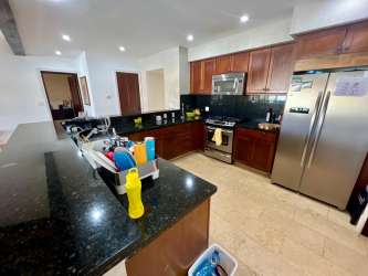 Contemporary kitchen with granite countertops, stainless appliances in luxury Buenaventura Bristol Villas Panama