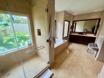 Spacious contemporary bathroom with marble floors, glass shower and bathtub in Bristol Villas Buenaventura Panama