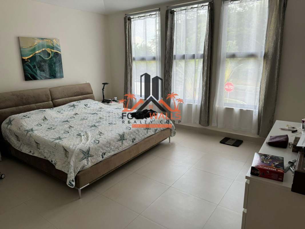 Modern bedroom with large window and built-in closet River Valley Panama house