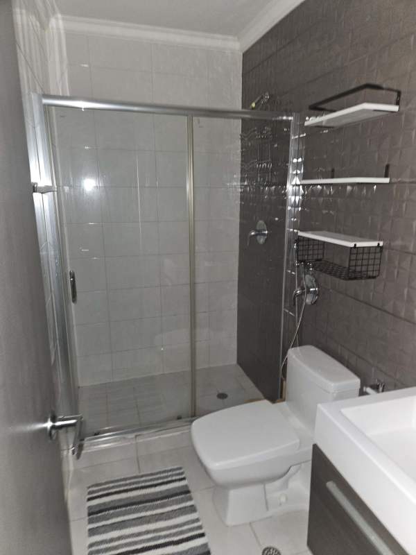 Furnished bedroom with split air conditioner, built-in closet, and city views at PH Metropolitan Park