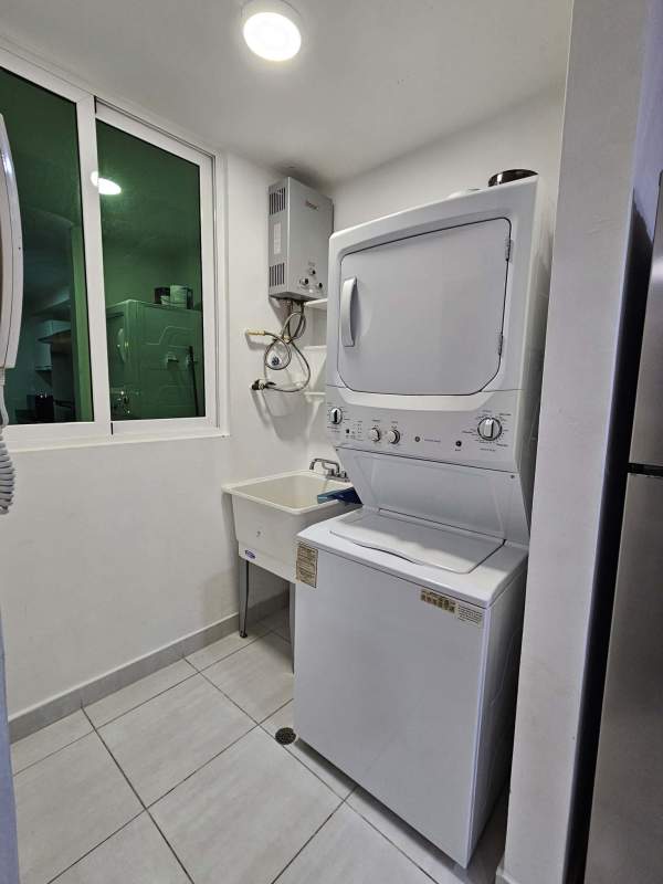 Modern bathroom with glass shower enclosure and tile walls at PH Metropolitan Park Panama