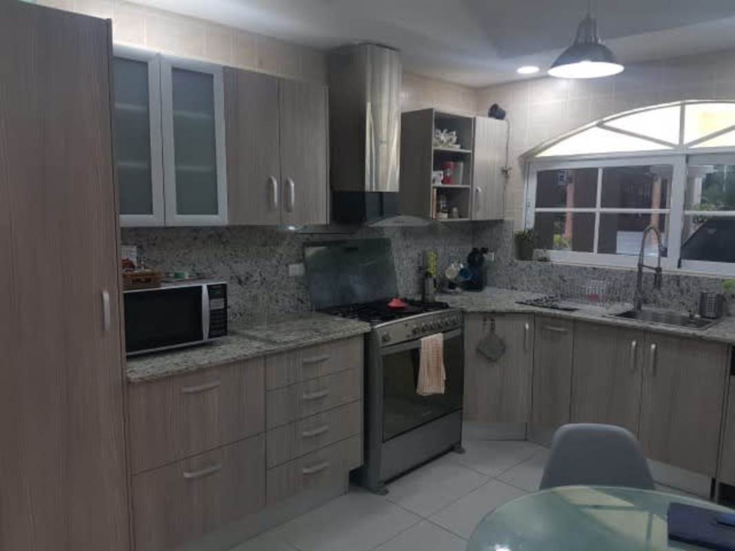 Indoor staircase with large window and iron railing house in Clayton