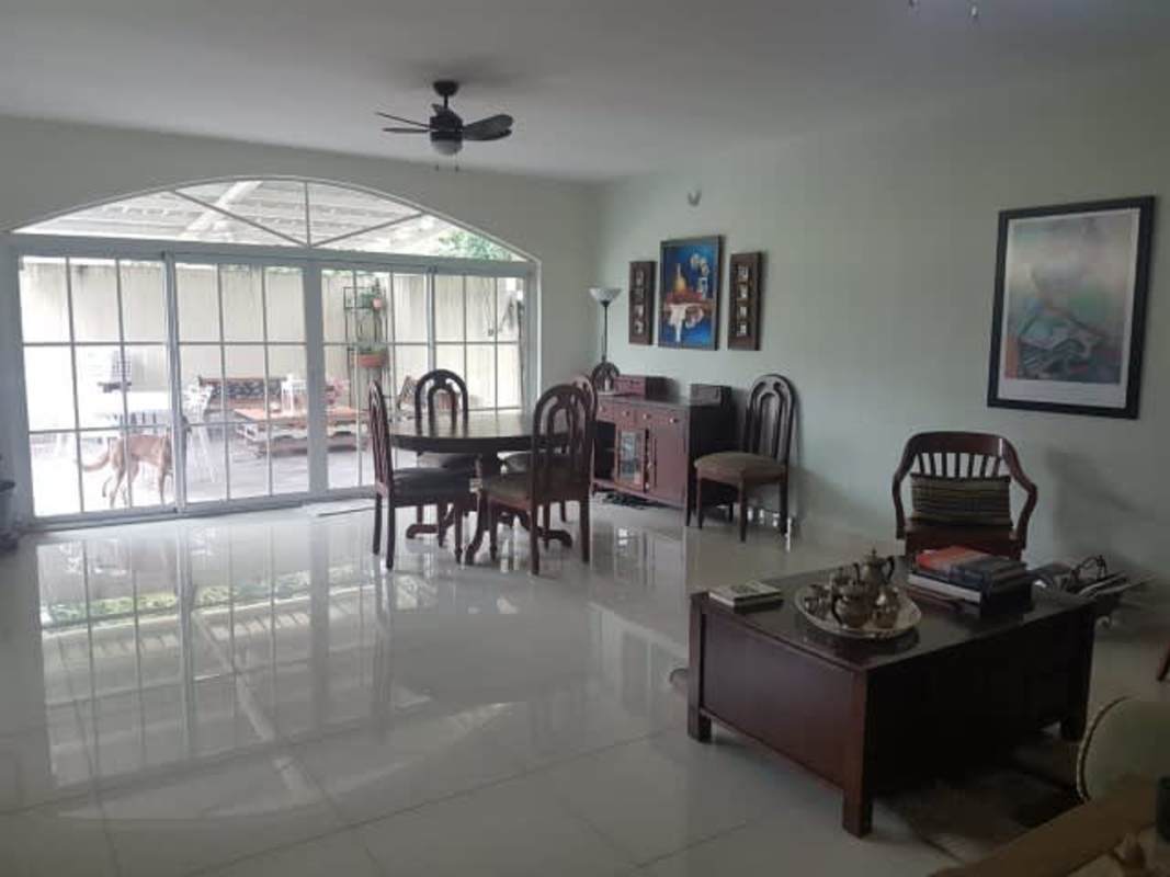 Open plan living dining area with terrace access in Clayton house
